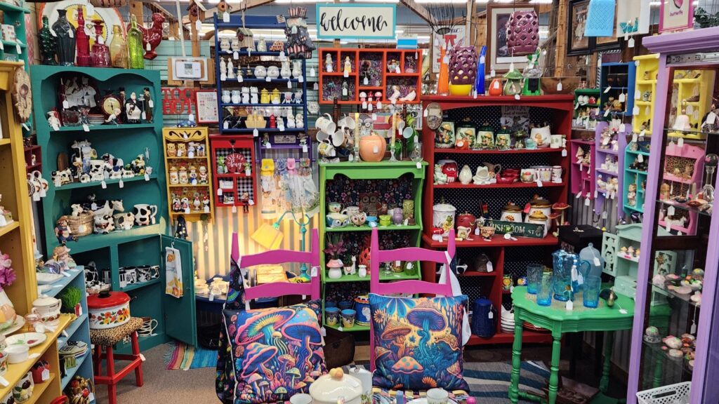 Antique mall booth display with layered shelves and full inventory designed to increase booth sales