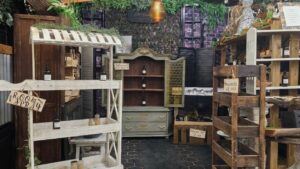 Antique mall booth with low inventory and empty shelves showing signs the booth may need restocking
