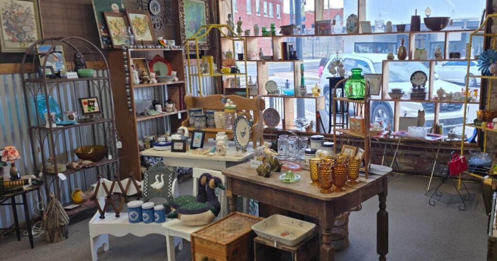 Example of an antique mall booth display showing how vendors arrange vintage items, glassware, and collectibles for sale
