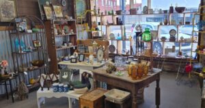 Example of an antique mall booth display showing how vendors arrange vintage items, glassware, and collectibles for sale